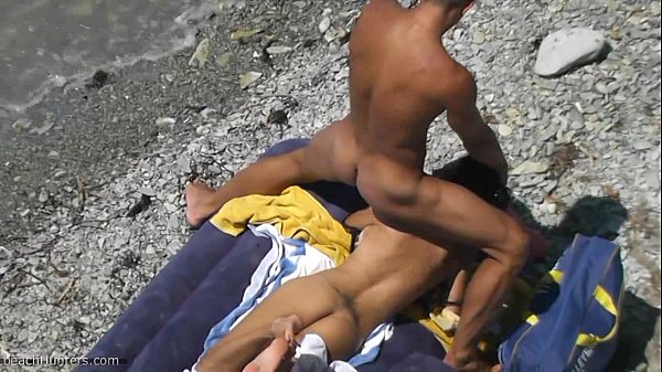 voyeur video of a couple having intense sex at the beach